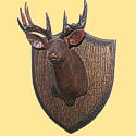 Wood carved plaque of an deer.